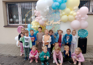 Zdjęcie grupy przedszkolnej na tle ścianki z balonami