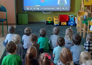 Dzieci oglądają film na tablicy multimedialnej