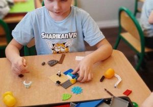 Chłopiec buduje z klocków LEGO