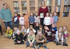 Zdjęcie grupowe w bibliotece dzieci i pracowników biblioteki